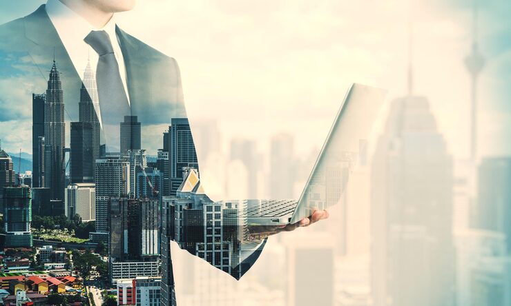 young businessman holding laptop 670147 23949